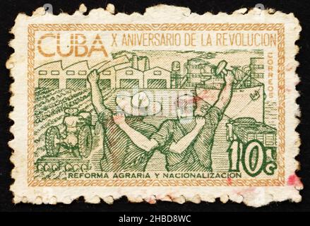 CUBA - CIRCA 1963: a stamp printed in the Cuba shows Agricultural Reform and Nationalization of Industry, 10th Anniversary of Cuban Revolution, circa Stock Photo