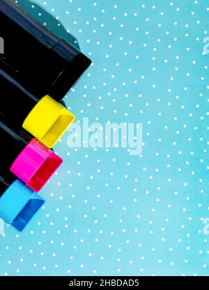 A set of toner cartridges for a color laser printer on a snowy background. Bright creative concept  christmas minimal Stock Photo