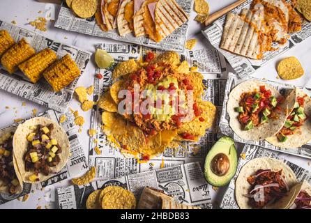 Photo above of a selection of many Mexican tapas, including tacos, guacamole, pico de gallo, nachos and others Stock Photo