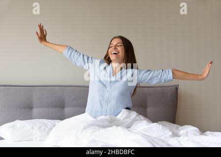 Relaxed happy young woman using computer at home. Stock Photo