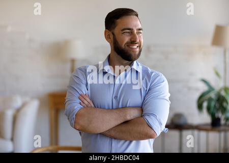 Happy dreamy confident young businessman looking in distance. Stock Photo