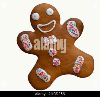 Isolated brown gingerbread man glazed with icing and decorated with colorful balls on white background Stock Photo