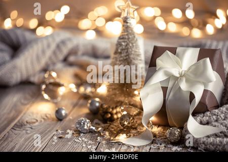 Christmas composition with a festive gift on a blurred background. Stock Photo