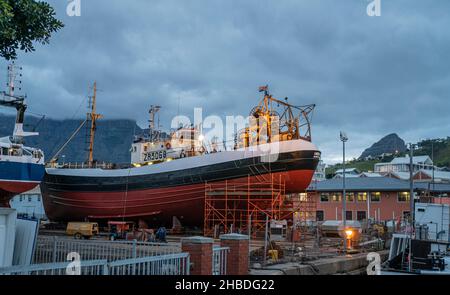 Ship in dry dock at Victoria and Alfred Waterfront at dusk, Cape Town, South Africa Stock Photo