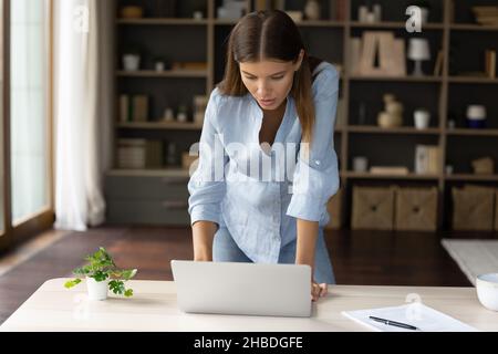 Happy beautiful young woman working on computer. Stock Photo