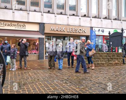 People watching a vintage traction engine on display in a town center Stock Photo