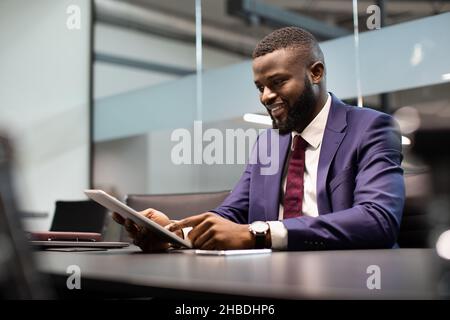 Cheerful black guy CEO working at office Stock Photo