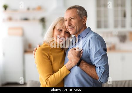 Happy Married Senior Couple Dancing Holding Hands At Home Stock Photo