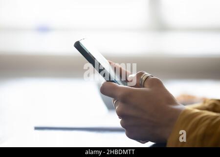 Close up side view young woman using smartphone. Stock Photo