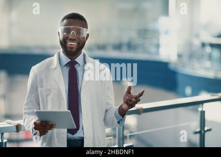 Handsome young african american scientist with digital tablet Stock Photo