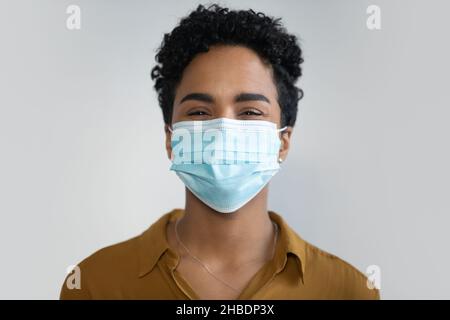 Portrait of happy millennial African American woman in facemask. Stock Photo