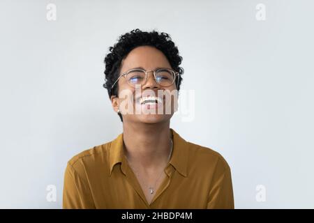 Overjoyed millennial African American woman in eyeglasses laughing. Stock Photo