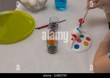 Close up view of child painting eggs for Easter. Holiday concept. Sweden. Stock Photo