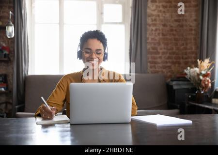 Happy young African American woman studying at home. Stock Photo