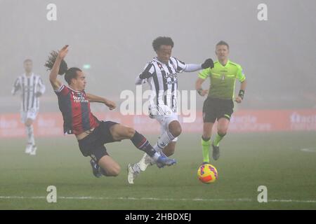 Bologna, Italy, 18th December 2021.  Arthur Theate of Bologna FC challenges Juan Cuadrado of Juventus during the Serie A match at Renato Dall'Ara, Bologna. Picture credit should read: Jonathan Moscrop / Sportimage Credit: Sportimage/Alamy Live News Stock Photo