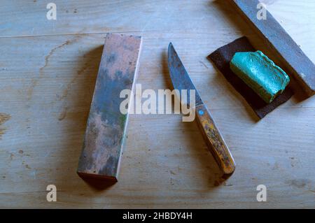 An old whetstone for sharpening knives. Grinding wheel on an old tripod.  Season of the autumn Stock Photo - Alamy