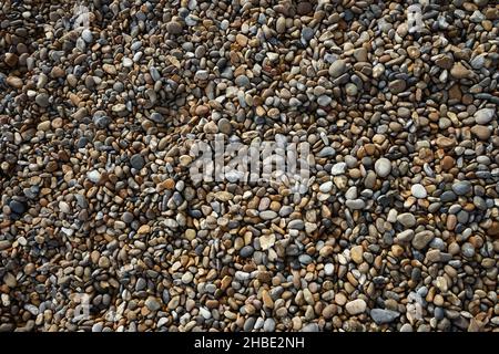 Looking down at an area of pebbles on a beach Stock Photo
