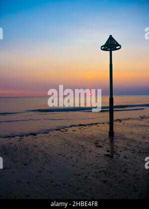 Sunset on the beach at Tywyn.A small seaside resort on the Cardigan Bay coast of southern Gwynedd, Wales Stock Photo