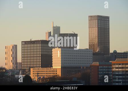 Manchester, UK, 19th December, 2021. A cold and sunny day with blue skies in Manchester, UK. Skyscrapers or high rise buildings in central Manchester, England, United Kingdom, seen from the South of the city. Credit: Terry Waller/Alamy Live News Stock Photo