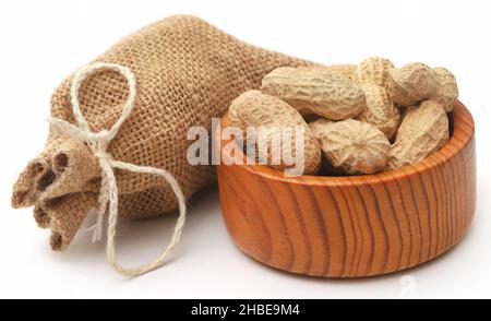 Fresh Peanuts in sack over white background Stock Photo