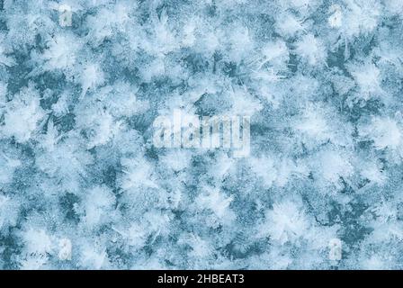 Frozen lake water in winter, ice crystals natural blue background Stock Photo