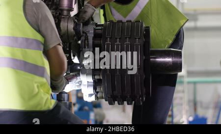 Calm workers controlling aircraft machine. Aircraft maintenance mechanic inspects plane chassis. Engine and chassis of the passenger airplane under he Stock Photo