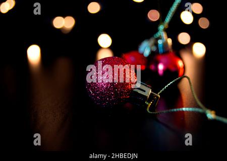 Coloured Christmas baubles and fairy lights Stock Photo