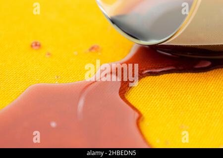 a spilled glass of wine on the tablecloth. Cleaning clothes and furniture from stains Stock Photo