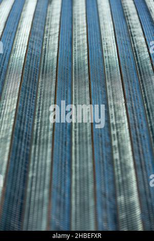 Long length of metal roofing sheet blue silver coloring with wavy texture Stock Photo