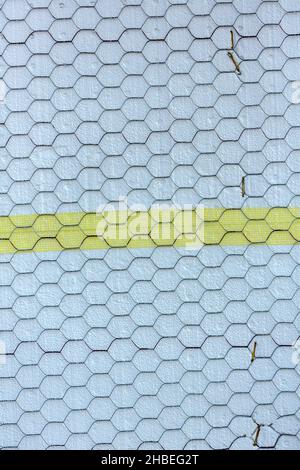 Moisture resistant foam stucco panels covered in construction mesh and yellow connecting tape Stock Photo