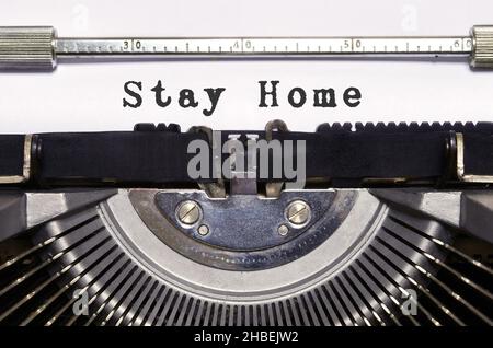 words 'Stay Home' typed on vintage typewriter. Covid 19 pandemic period. Stock Photo