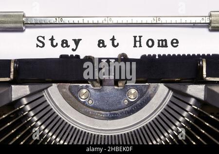 words 'Stay at Home' typed on vintage typewriter. Covid 19 pandemic period. Stock Photo