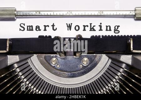 words 'Smart Working' typed on vintage typewriter.Pandemic Covid 19 period. Time for increase home smart working. Stock Photo