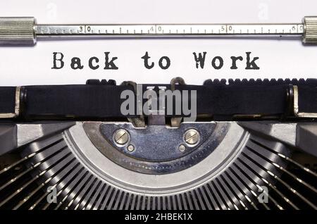 Words 'Back to work' typed on vintage typewriter.End of pandemic Covid 19 period. Time for back to office work. Stock Photo
