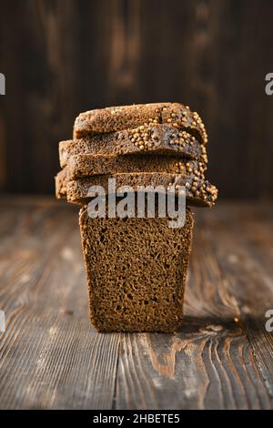 Closeup view of fresh rye brown bread on wooden cutting board Stock Photo