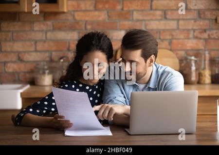 Happy positive family couple reading paper letter. Stock Photo