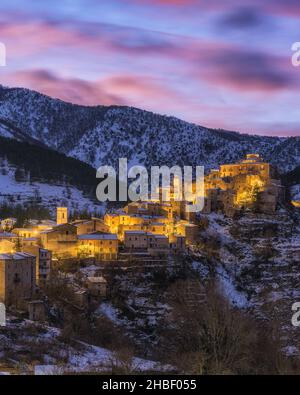 The beautiful village of Villalago, covered in snow at sunset during winter season. Province of L'Aquila, Abruzzo, Italy. Stock Photo