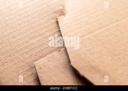 Grungy delivery box paper texture. Recycled sheet of folded cardboard with rough edges. Macro Stock Photo