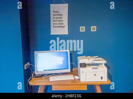 Desk with computer, printer on tha table in the lobby hall of the hotel Stock Photo
