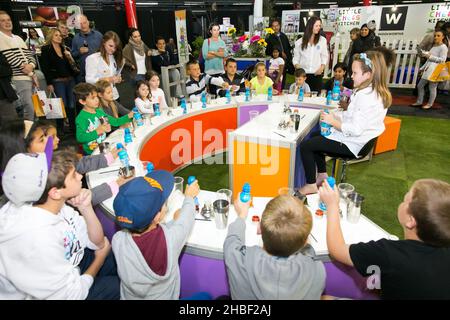 JOHANNESBURG, SOUTH AFRICA - Oct 15, 2021: Some kids interacting with exhibitors at Food and Wine Expo Stock Photo