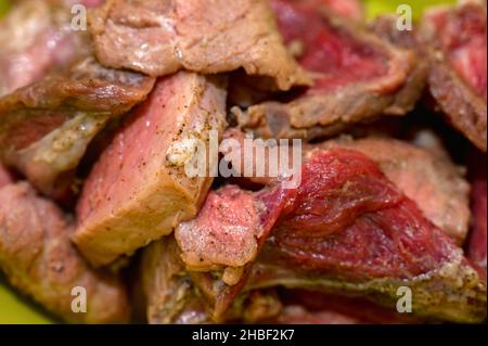 View of raw pork chopped on small pieces and seasoned with peper and salt Stock Photo