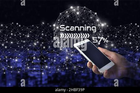 Global world telecommunication network. Hand hold white smartphone with digital hologram scanner sign on city dark blurred background. Futuristic and Stock Photo