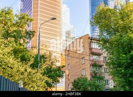 Moscow-City glass towers skyscrapers.behind old soviet khruschevka residential buildings in Moscow, Russia. Concept- city development, urbanisation. Stock Photo