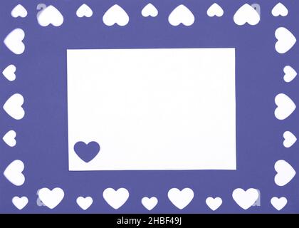 Valentines day mockup. Greeting card with hearts and white paper on a violet background. Color of the year 2022 Very Peri. Copy space, top view, flat Stock Photo