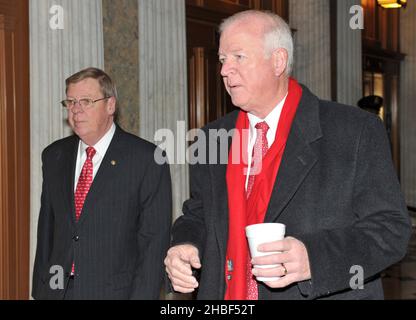 Washington, DC - December 24, 2009 -- United States Senators Johnny Isakson (Republican of Georgia), left, and Saxby Chambliss (Republican of Georgia), right, arrive to vote on H.R. 3590, regarding health care reform in the U.S. Capitol on Thursday, December 24, 2009. In a party-line vote, the bill passed 60 - 39.Credit: Ron Sachs/CNP.(RESTRICTION: NO New York or New Jersey Newspapers or newspapers within a 75 mile radius of New York City) Stock Photo