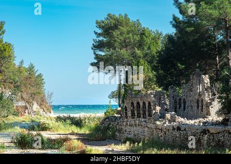 ruins of ancient roman bathhouse at the mouth of the river flowing into the sea in the ancient city of Olympus, Turkey Stock Photo