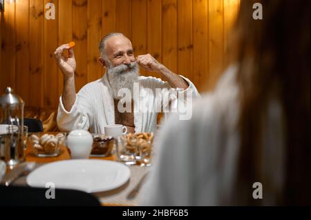 Senior man rest with friends in sauna Stock Photo