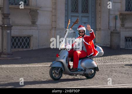 Rome, Italy- December 19, 2021: Santa Claus rides a motor scooter around Rome Stock Photo