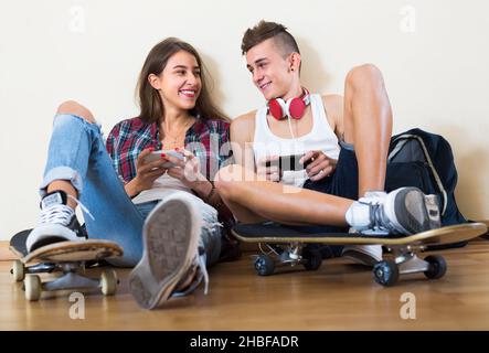 Girl and boy playing games online Stock Photo