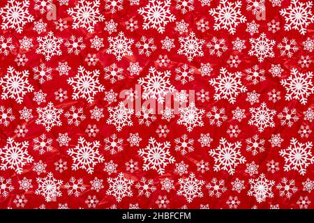 White snowflakes on a red background crumpled  wrapping paper. Christmas Holiday concept. Stock Photo